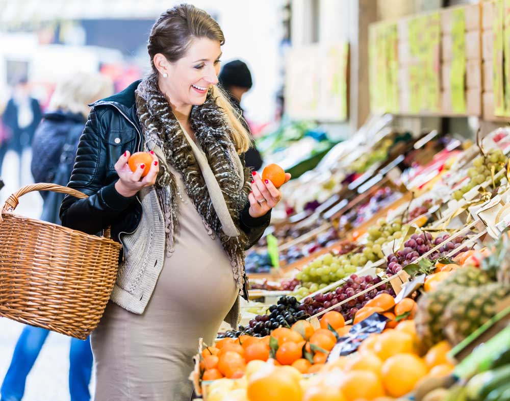 Pregnant woman shopping for produce