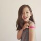 Young girl with pink bandage on arm