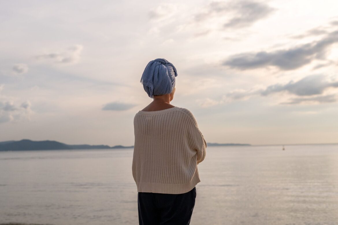 Woman standing in front of lake
