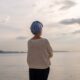Woman standing in front of lake