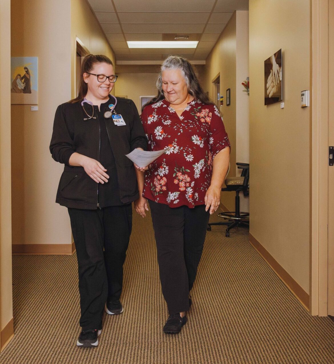two nurses reviewing paper